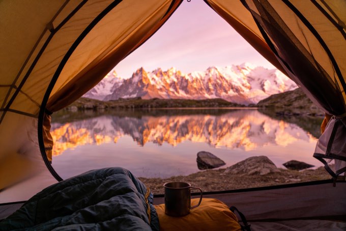A breathtaking photo from the perspective of someone sitting inside a tent, look